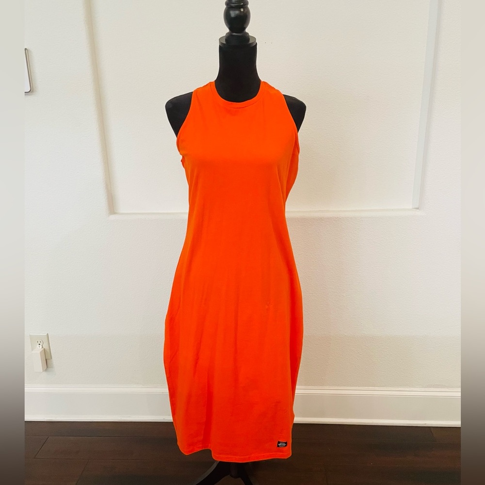 Orange sleeveless dress with crochet back. It’s a fitted dress
